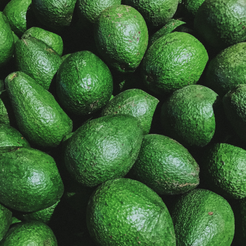 A close photo of many avocados