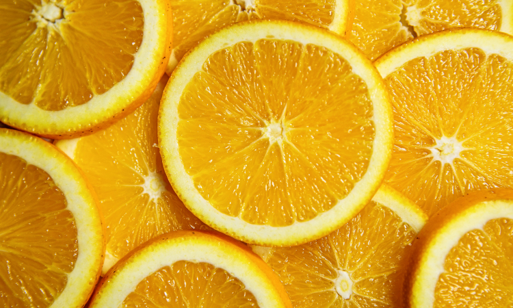 A close photo of sliced oranges laid flat