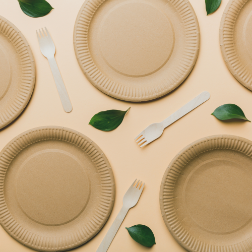 Place settings interspersed with single leaves and forks.